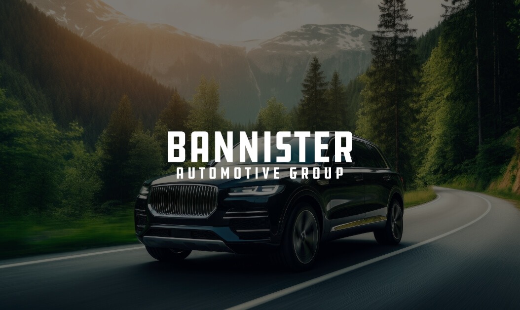 Luxury black SUV on mountain road with Bannister Automotive Group logo, highlighting premium automotive services.